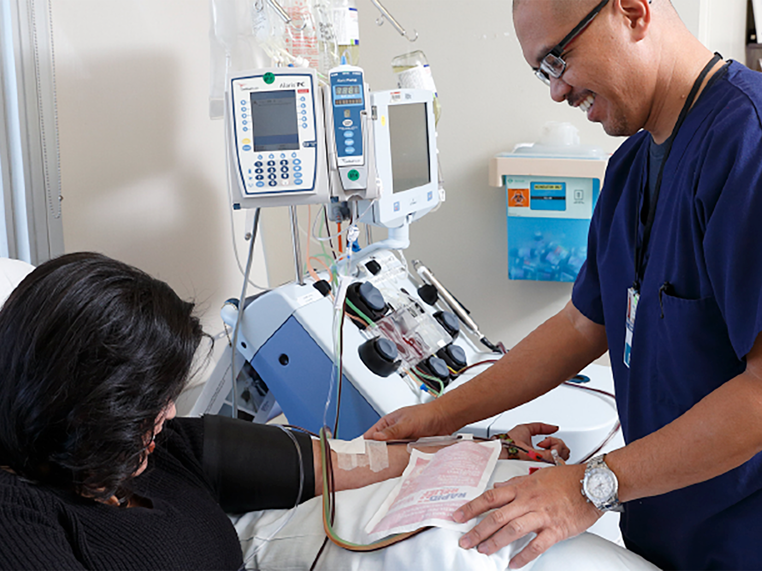 patient with healthcare provider and a spectra optia machine