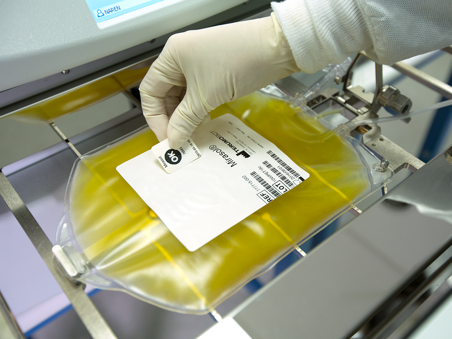 operator placing sticker on plasma bag