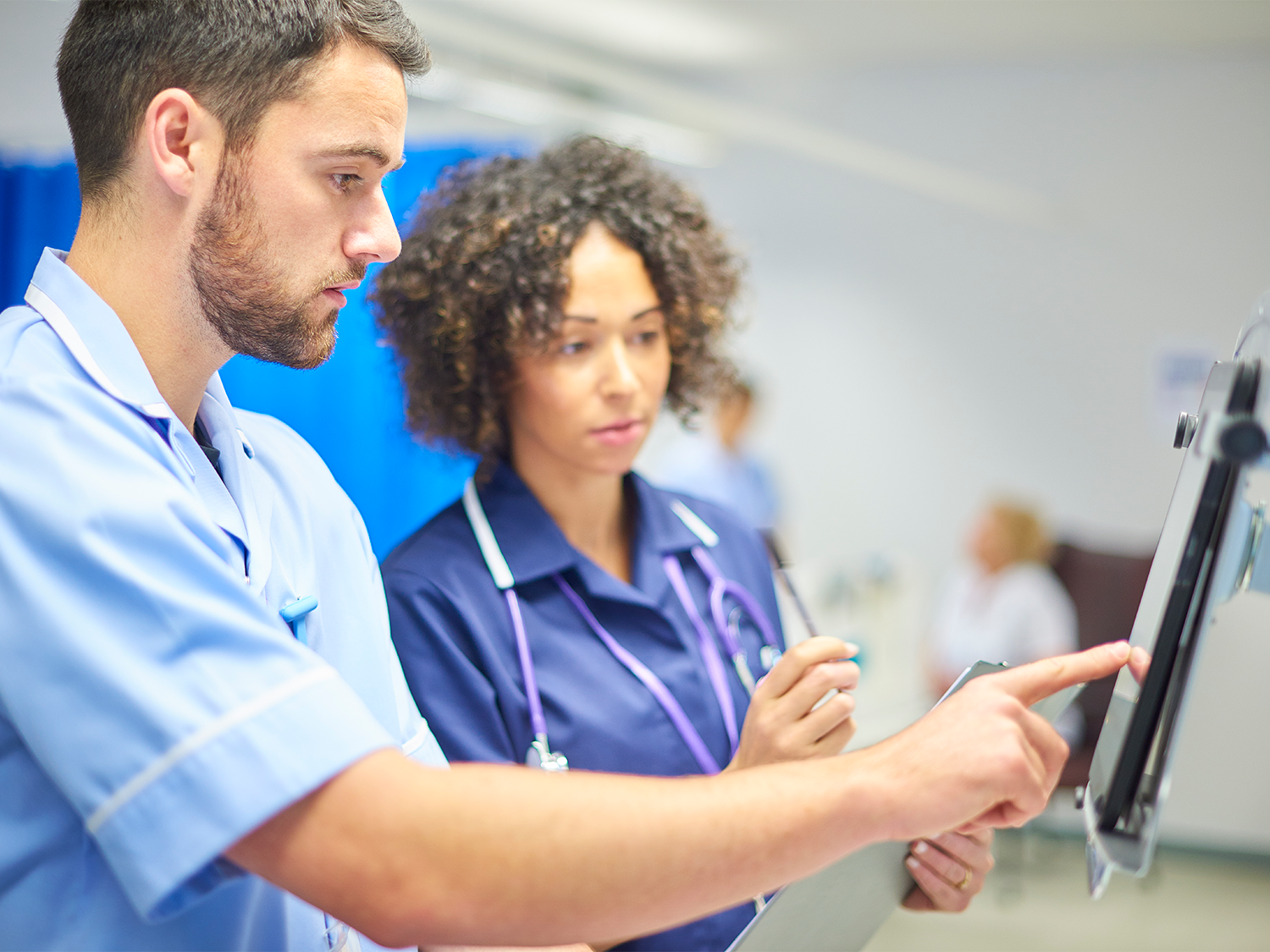 Healthcare professionals working on a computer