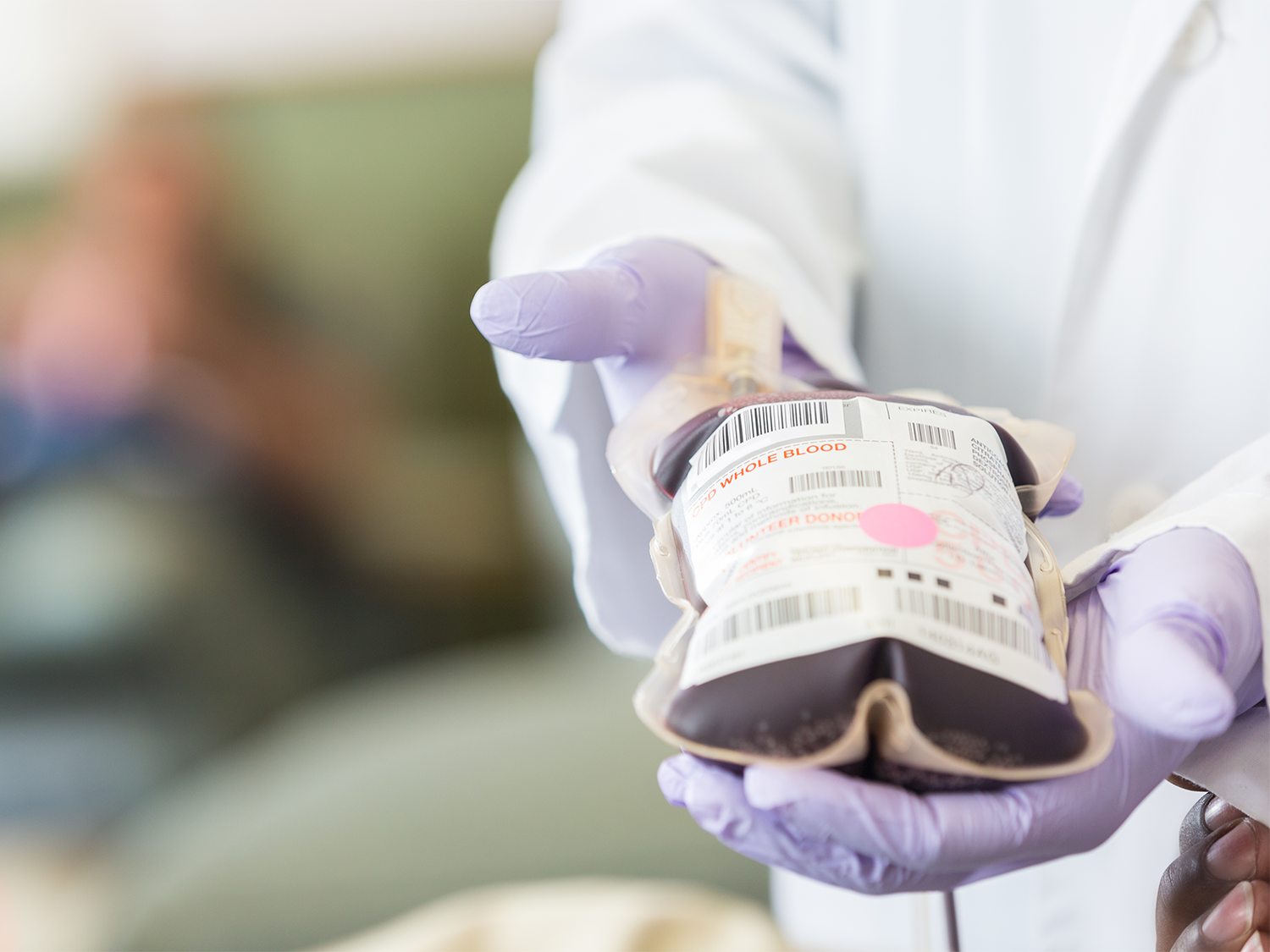 Healthcare professional holding a bag of whole blood